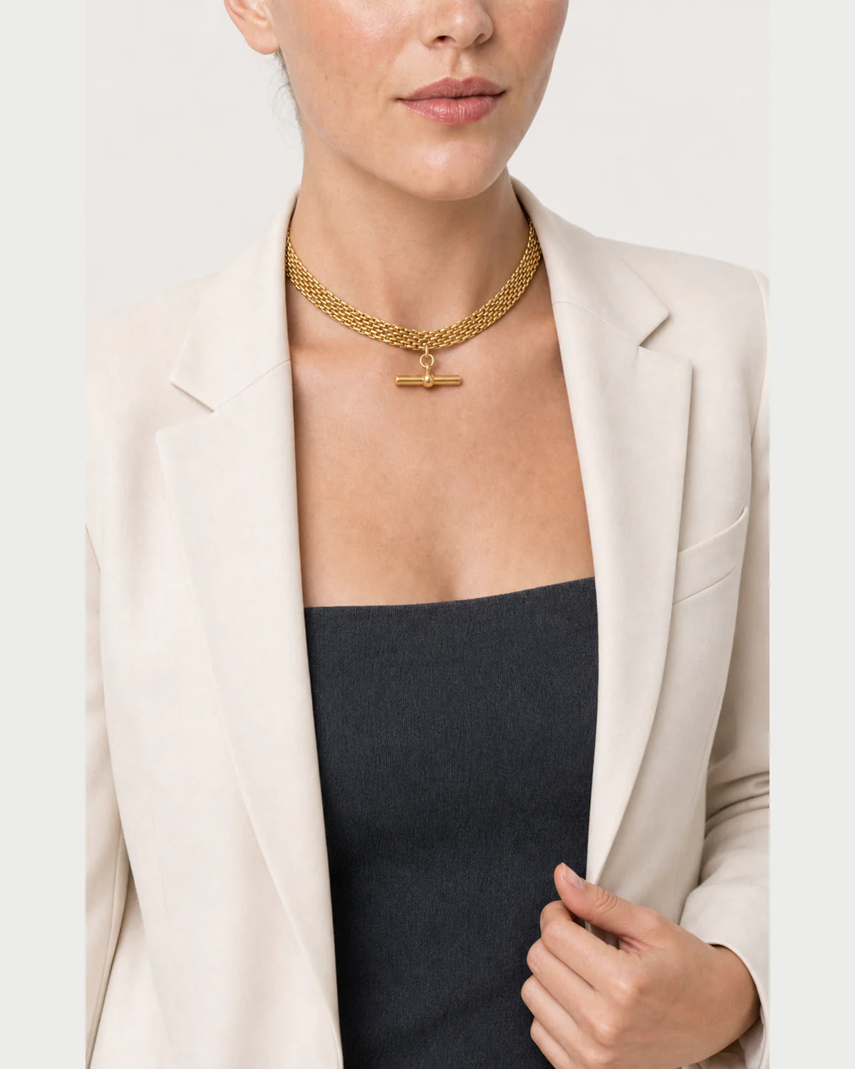 Model holding her blazer lapel while wearing the Camille collar