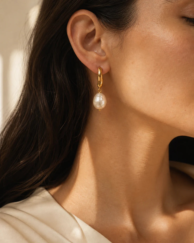 Mirelle pearl drop earring worn in warm editorial light
