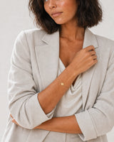 Alternate studio portrait of the same model wearing the Amara initial A bracelet