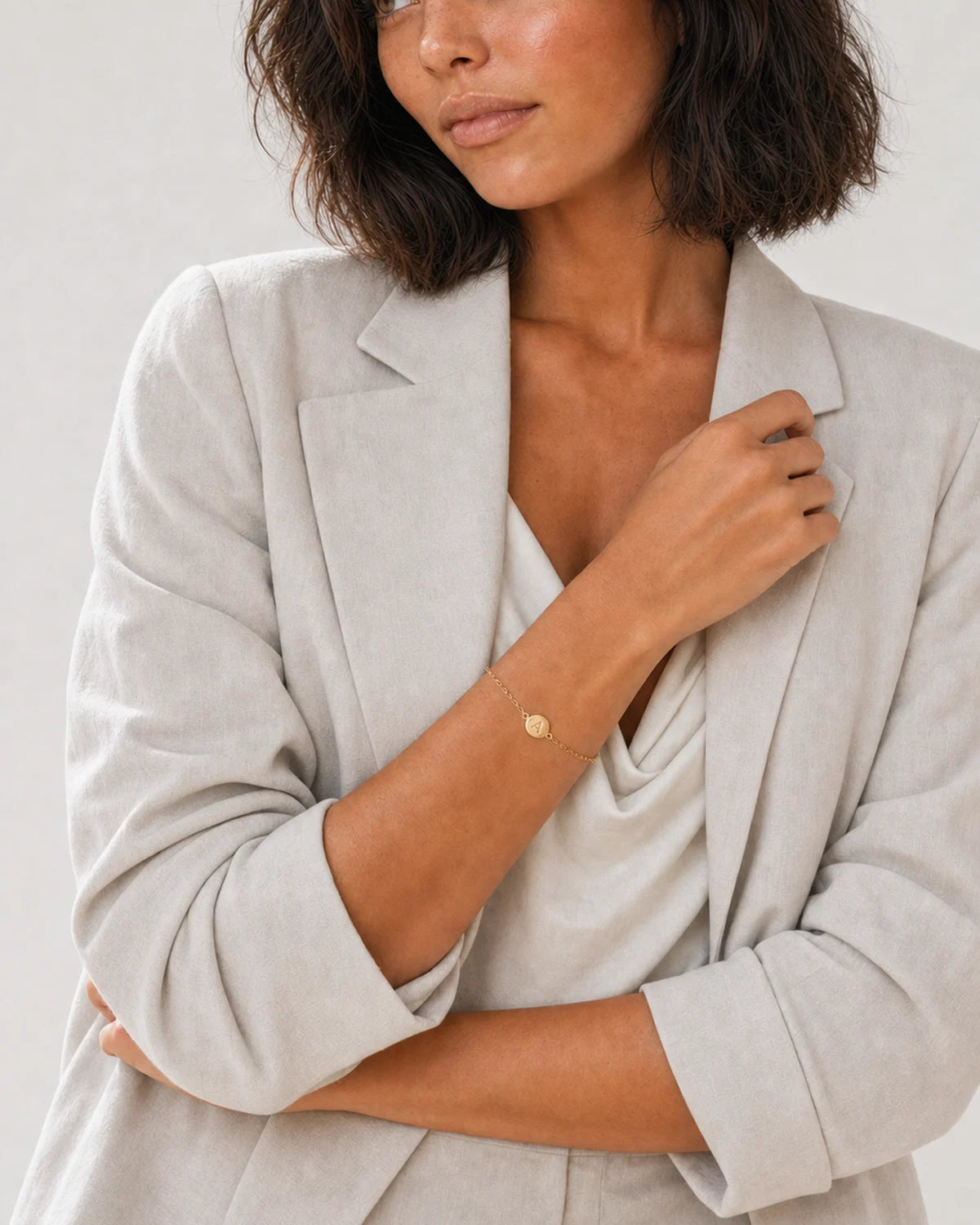 Alternate studio portrait of the same model wearing the Amara initial A bracelet