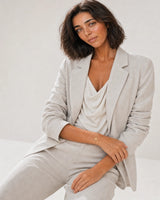 Wide editorial studio portrait showing the Amara initial A bracelet at natural scale