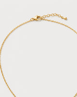 Clasp and extender detail of the Amara initial medallion necklace on pale dove-grey