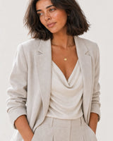 Alternate studio portrait of the same model wearing the Amara initial medallion necklace