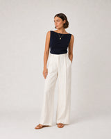 Full-body navy and cream summer portrait featuring the Amara necklace