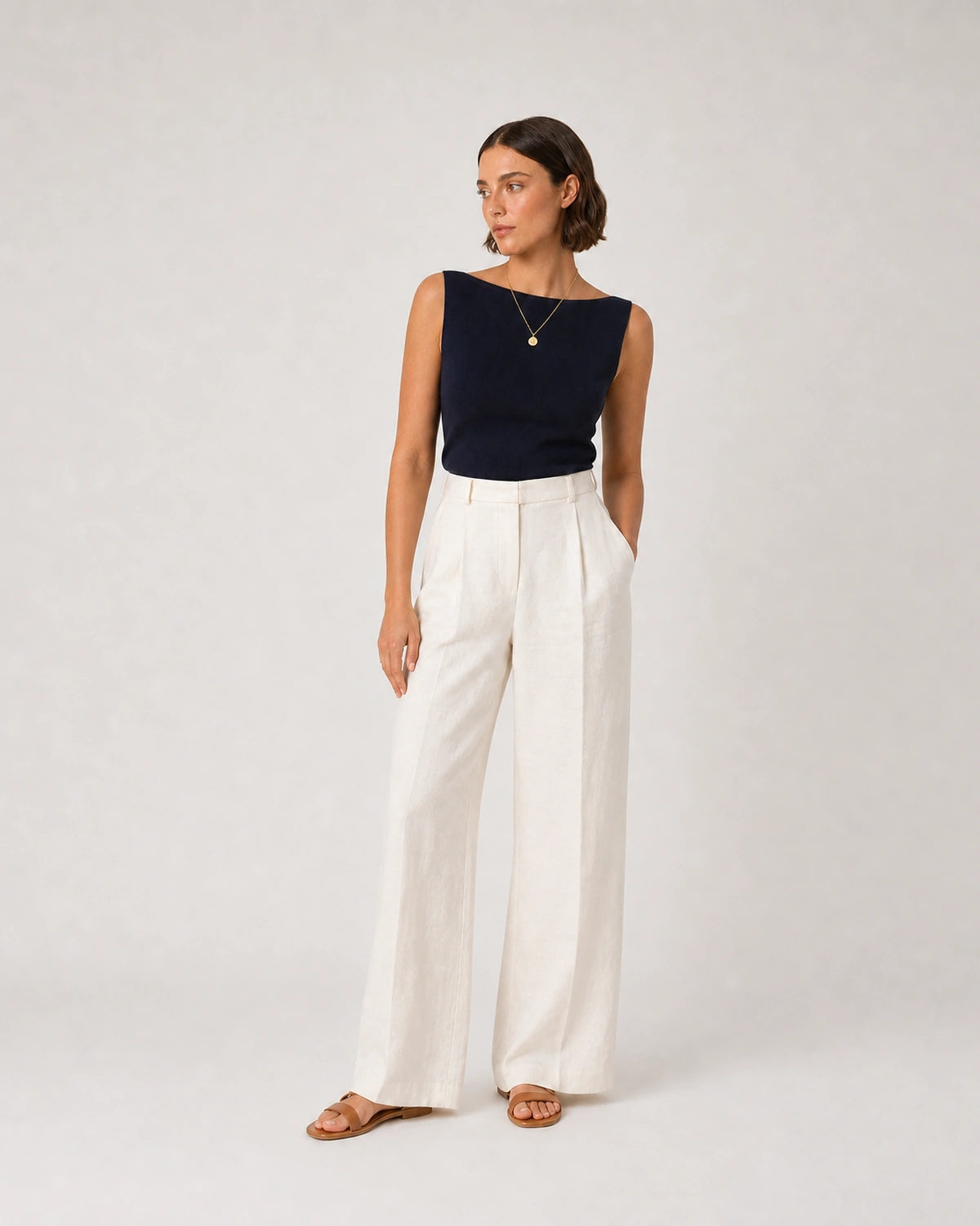 Full-body navy and cream summer portrait featuring the Amara necklace