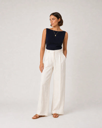 Full-body navy and cream summer portrait featuring the Amara necklace