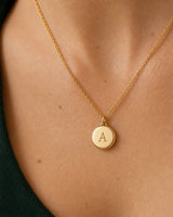Complete worn macro of the gold Amara serif-A medallion