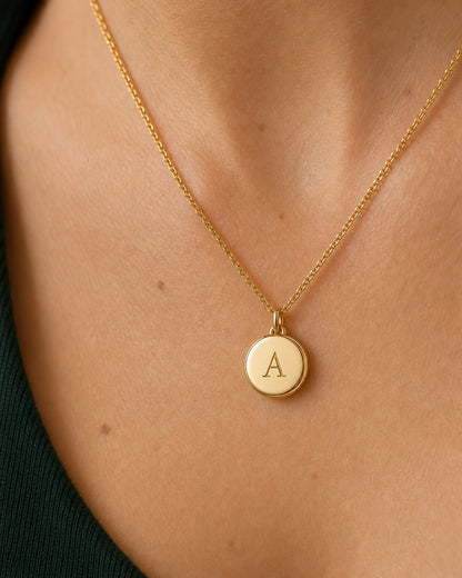 Complete worn macro of the gold Amara serif-A medallion