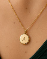 Extreme worn macro of the gold Amara serif A, dome, bail and cable chain
