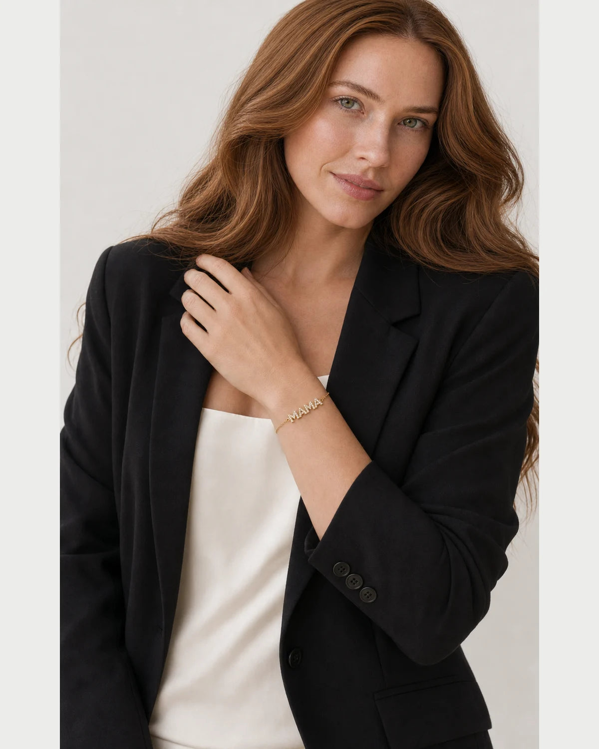 Model in black tailoring wearing the Amaya pave MAMA bracelet