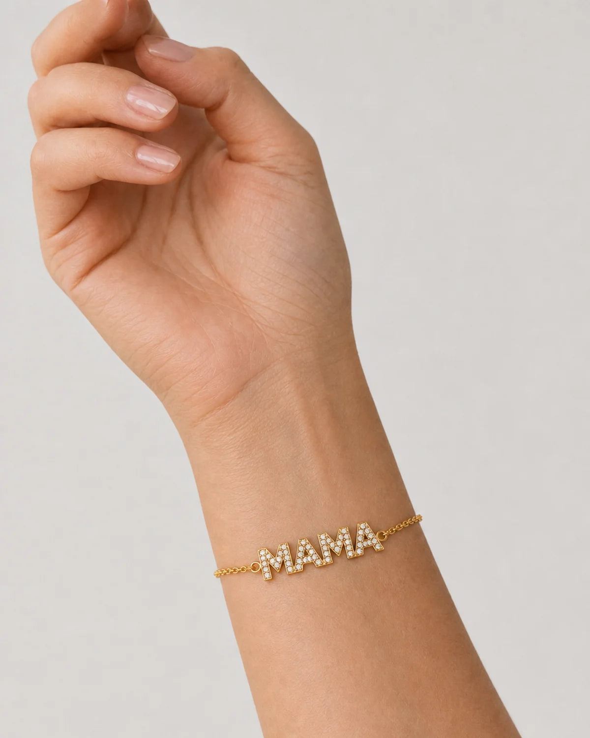 Close wrist view of the Amaya gold pave MAMA bracelet