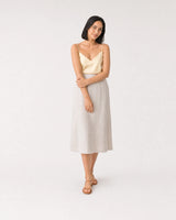 Full-body silk and linen summer portrait featuring the Amaya bracelet