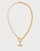 Amélie pearl and gold chain toggle necklace on pale dove-grey