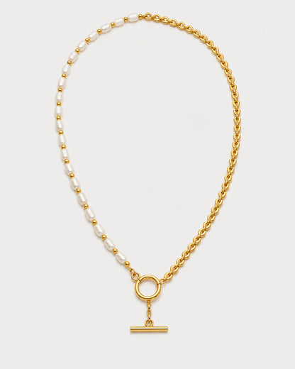 Amélie pearl and gold chain toggle necklace on pale dove-grey