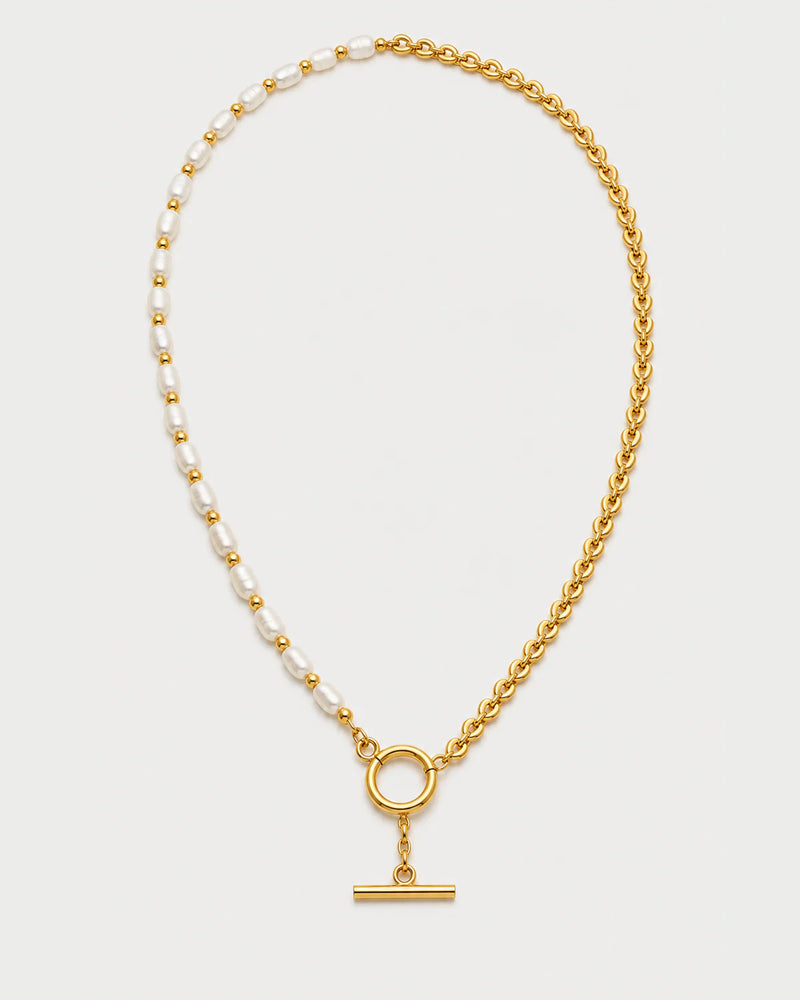 Amélie pearl and gold chain toggle necklace on pale dove-grey