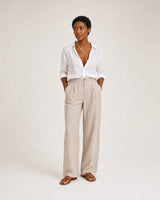 Full-body white and stone linen summer portrait featuring the Amélie necklace