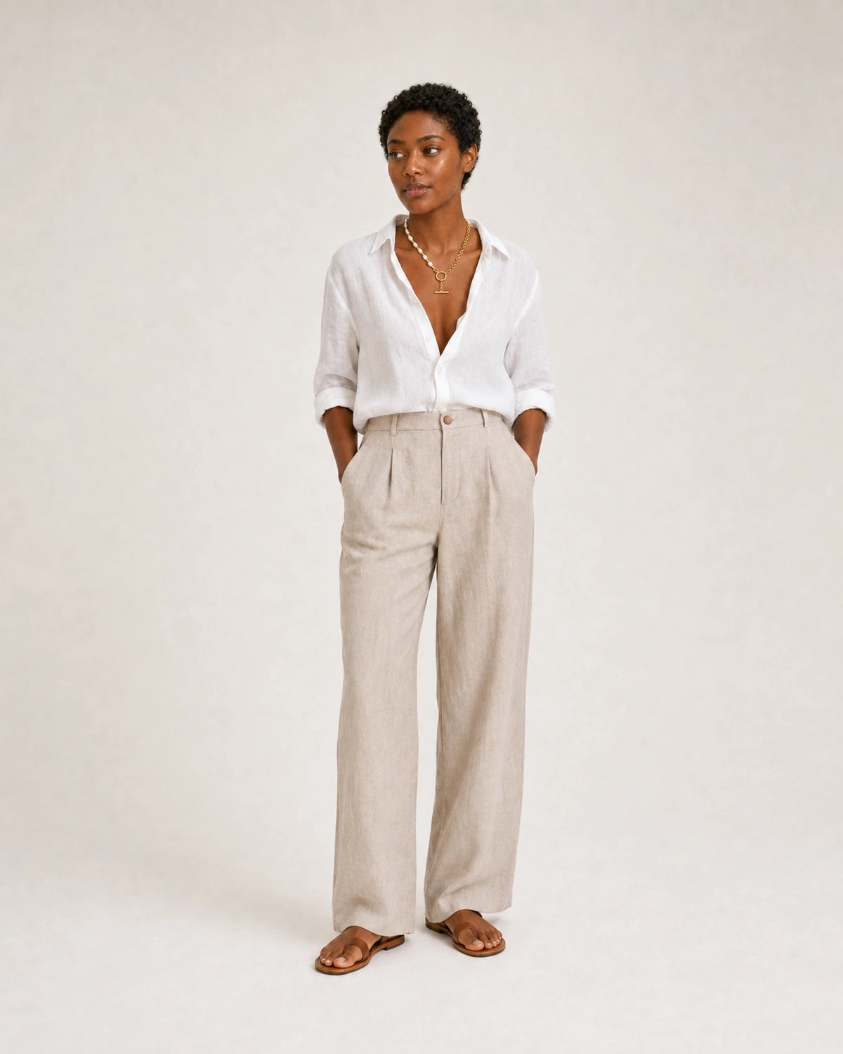 Full-body white and stone linen summer portrait featuring the Amélie necklace
