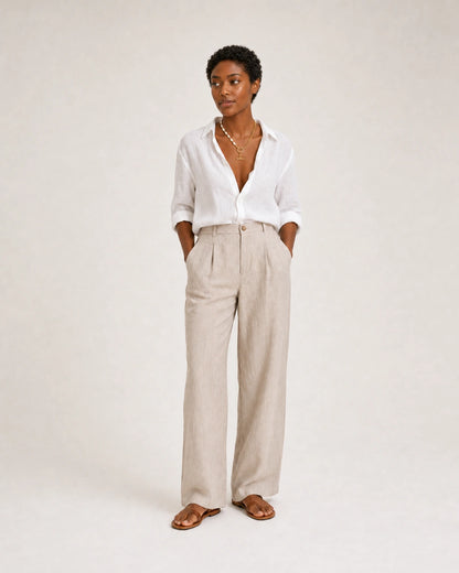 Full-body white and stone linen summer portrait featuring the Amélie necklace