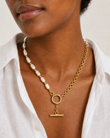 Close neckline view of Amélie pearls, gold chain, toggle ring and T-bar
