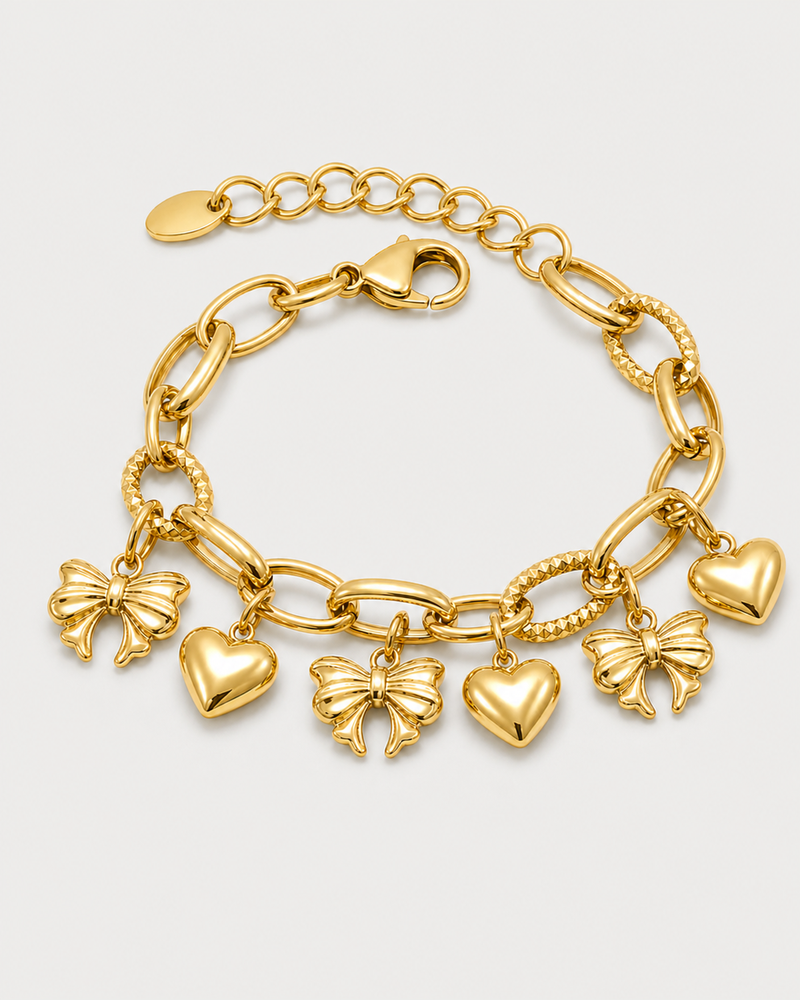 Amorette gold bracelet with three heart and three bow charms on seamless pale dove-grey