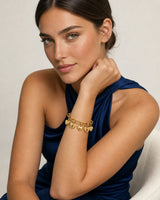 Model in a cobalt Santorini silk halter dress wearing the Amorette heart and bow bracelet
