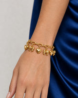 Close wearing view of three Amorette gold hearts and three ribbon bows