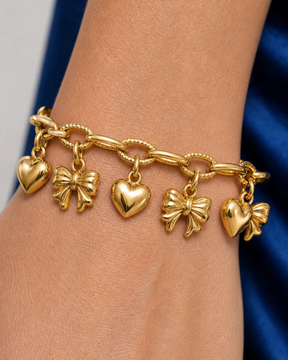 Extreme wrist macro of the alternating Amorette heart and bow charms