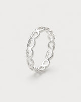 Amoura silver open-heart band ring on pale dove-grey