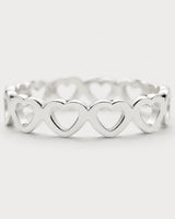 Macro view of the repeating upright hearts on the Amoura silver ring