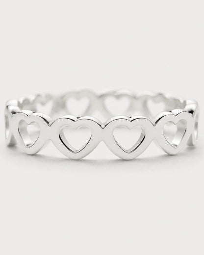 Macro view of the repeating upright hearts on the Amoura silver ring