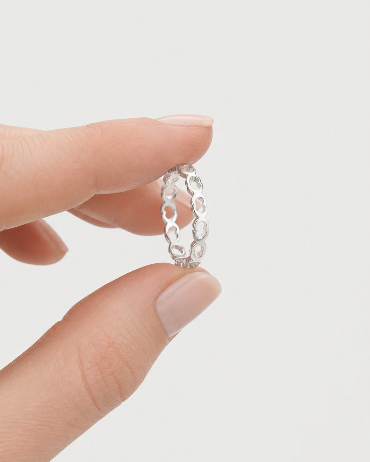 Hand-held scale view of the slim Amoura silver ring