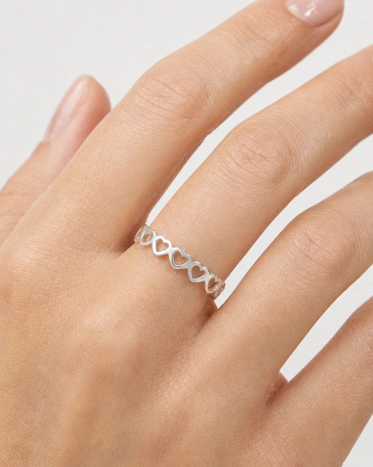Extreme on-hand macro of the Amoura open-heart band ring
