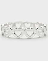 Macro of the repeating upright hearts and polished silver Amoura band