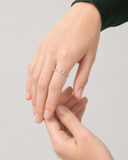 Three-quarter hand pose of Camille wearing the silver Amoura heart band