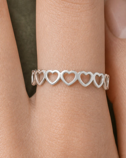 Extreme on-hand macro of the Amoura repeating upright silver hearts