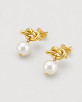 Apolline gold knot pearl earrings in an alternate studio arrangement
