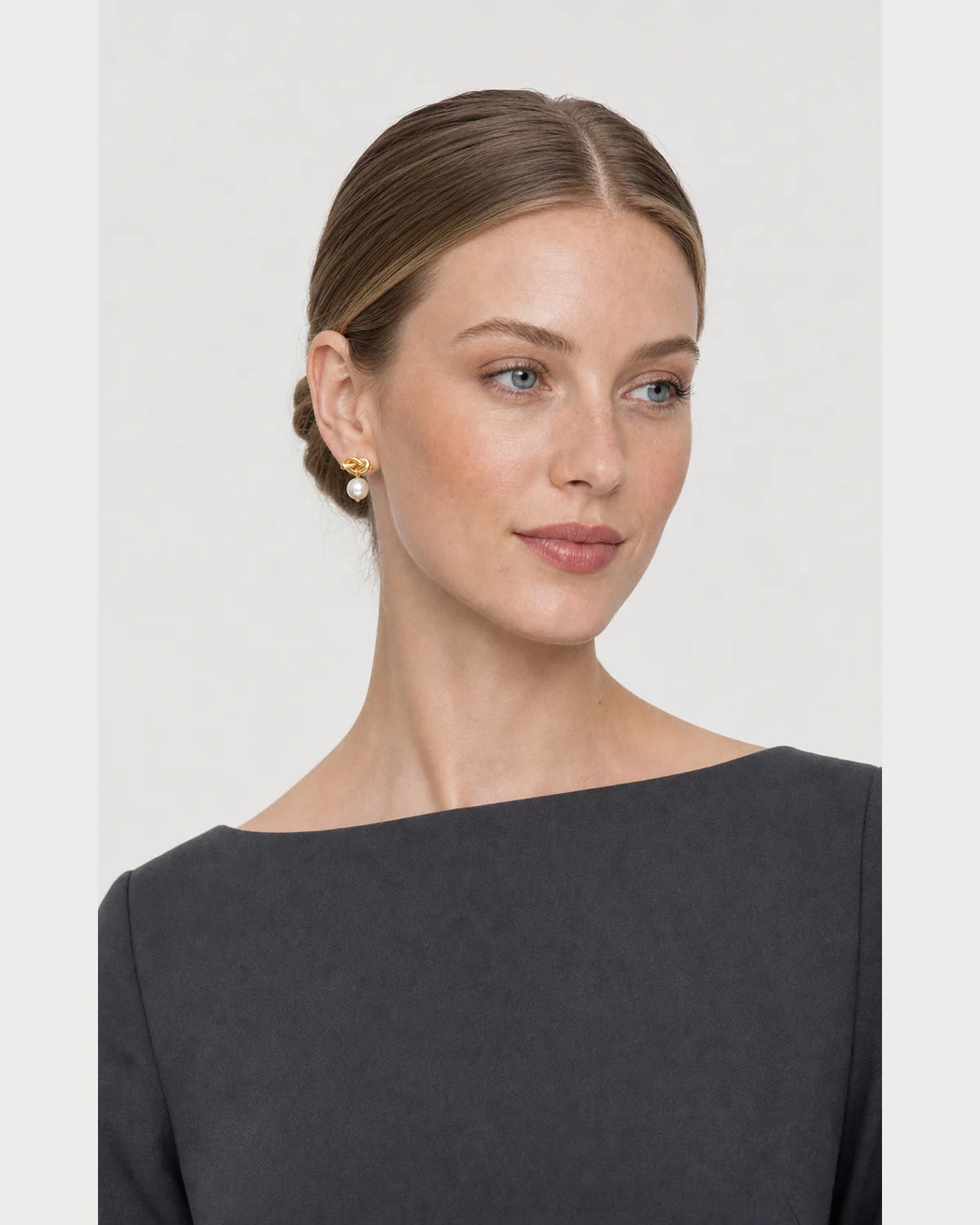 Three-quarter studio portrait featuring the Apolline pearl earrings