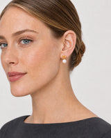 Close side portrait showing the Apolline gold knot pearl earring