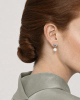 Eye-free rear three-quarter view of Laurel wearing the silver Apolline earring