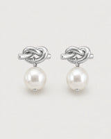 Apolline silver knot pearl drop earrings on pale dove-grey