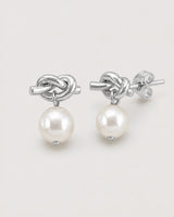 Macro view of the Apolline silver knot, pearl drops and stud backs