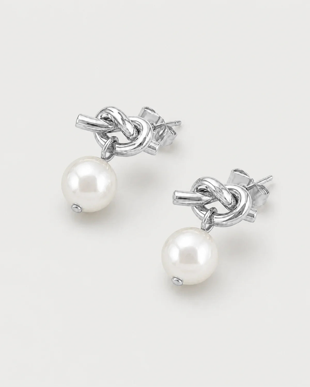 Apolline silver knot pearl earrings in an alternate studio arrangement