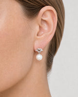 Extreme on-ear macro of the Apolline silver knot and pearl drop