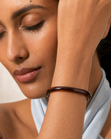 Extreme on-body macro of the translucent Arden slim espresso resin bangle