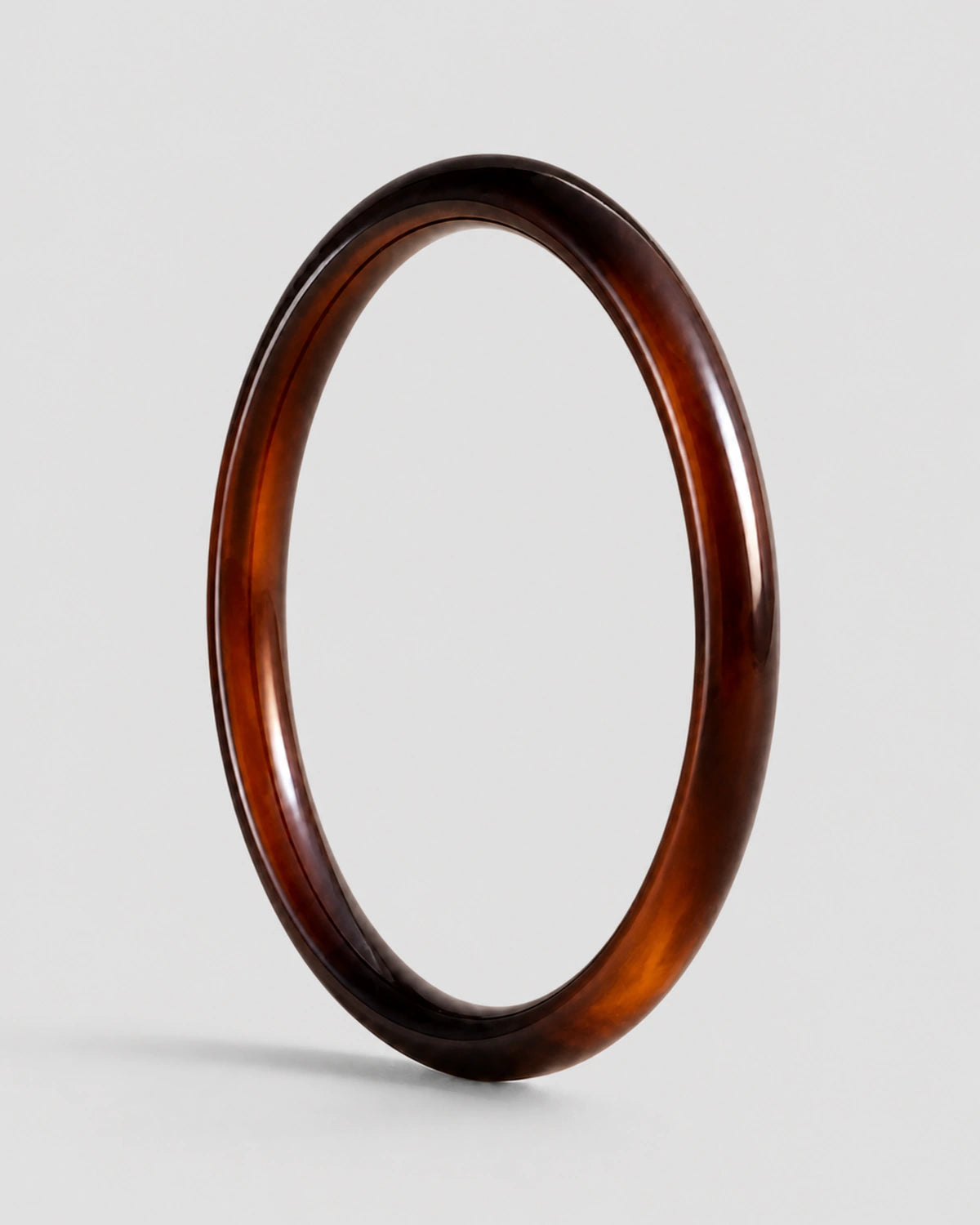 Arden slim espresso resin bangle on warm soft ivory