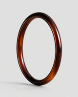 Arden slim espresso resin bangle on warm soft ivory
