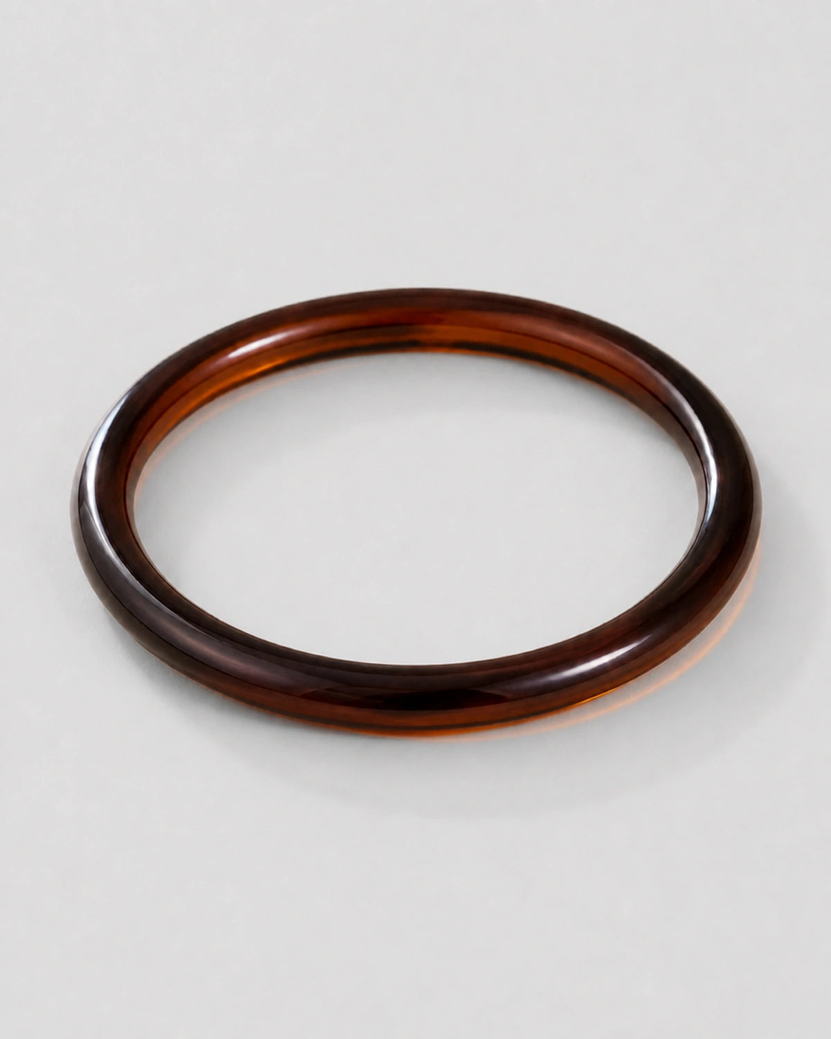 Alternate flat-lay view of the seamless Arden slim espresso bangle