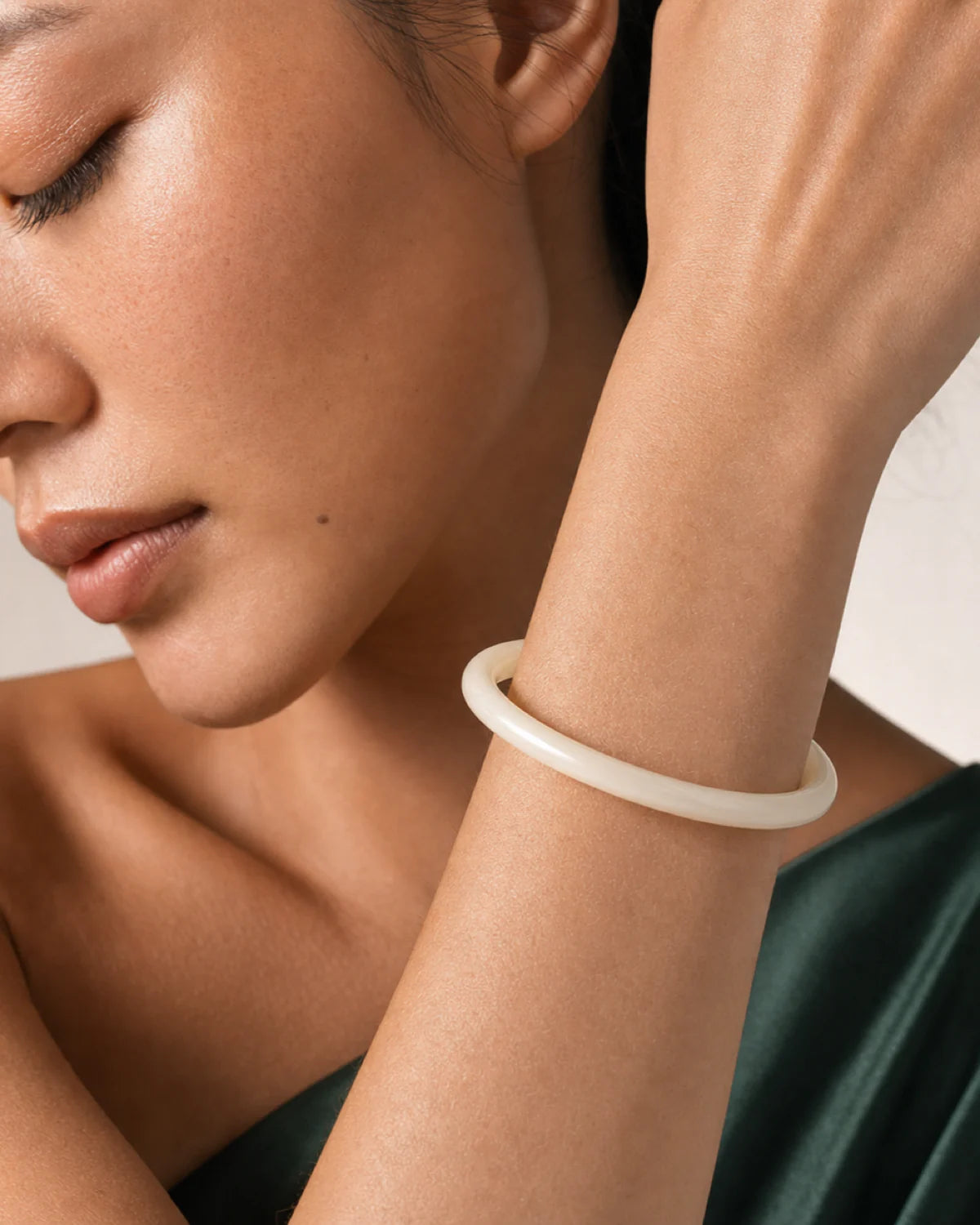 Extreme on-body macro of the polished Arden slim ivory resin bangle