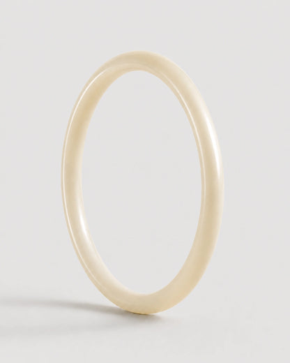 Arden slim ivory resin bangle on warm soft ivory
