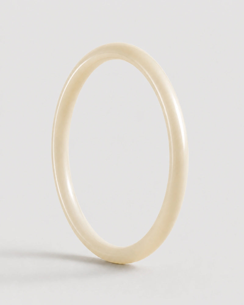 Arden slim ivory resin bangle on warm soft ivory